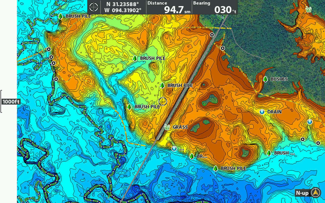 Topographic map showing elevation contours and features like brush piles and drains, marked for navigation.